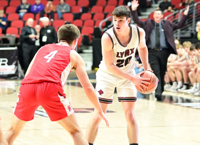 North Linn's Mason Bechen scans the court while being guarded by Bellevue Marquette's Caden Kettmann during the Class 1A state championship game at Wells Fargo Arena in Des Moines on Friday. (Photo by Ryan Timmerman)